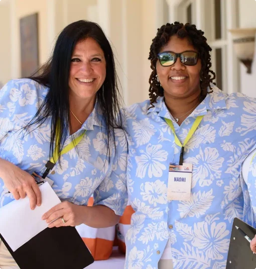 Two M&IW event staff in matching shirts at an event