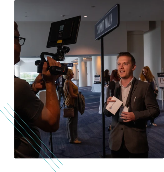 Camera crew interviewing a speaker at an event