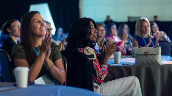 Audience clapping at a conference session