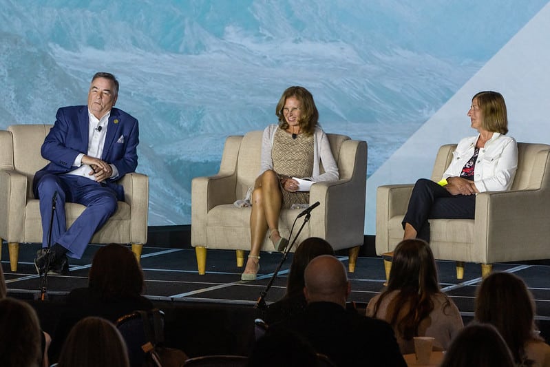Mike Farmer, Lisa Palmeri Oleson, and Vicki Walsh speak at the 2022 M&IW Summit