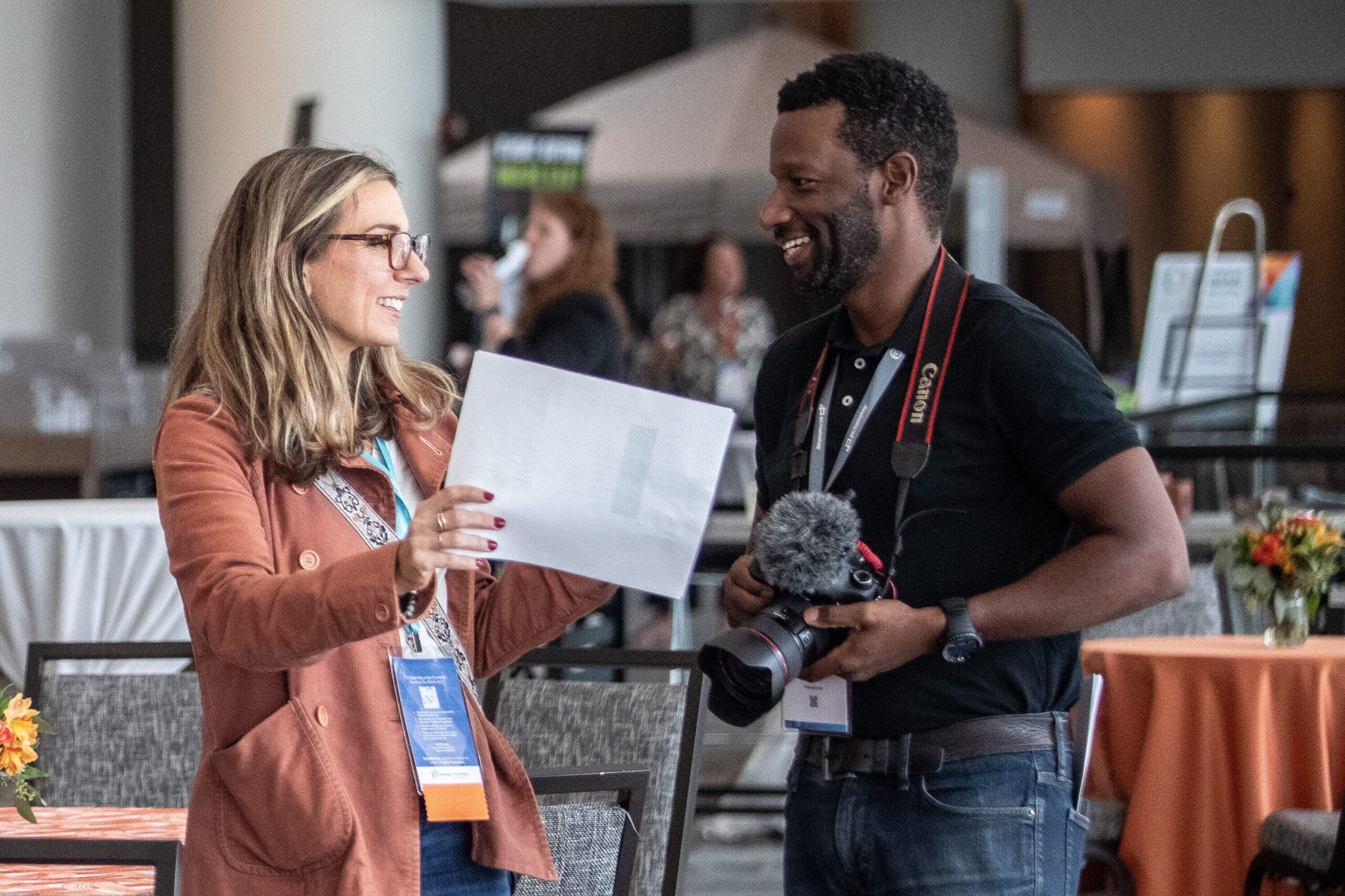 An event planner reviews the photo shot list with the photographer before attendees arrive at the 2025 M&IW Summit
