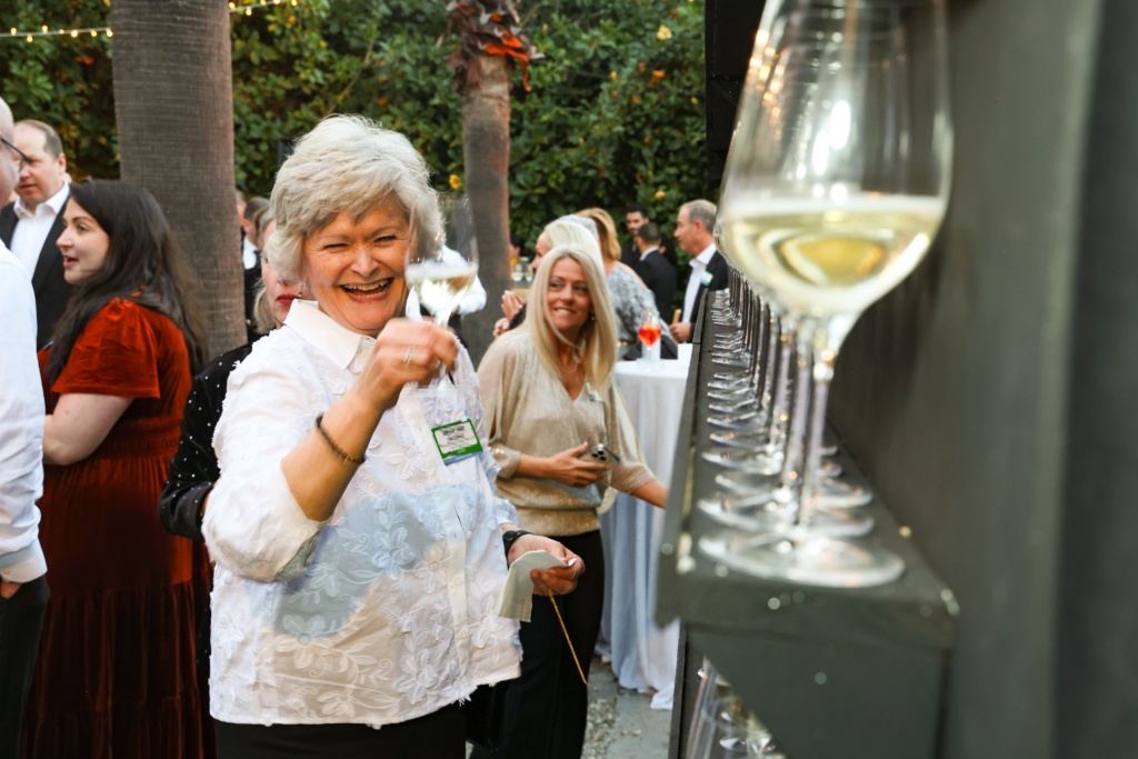 Incentive trip attendee smiling and holding a glass of champagne