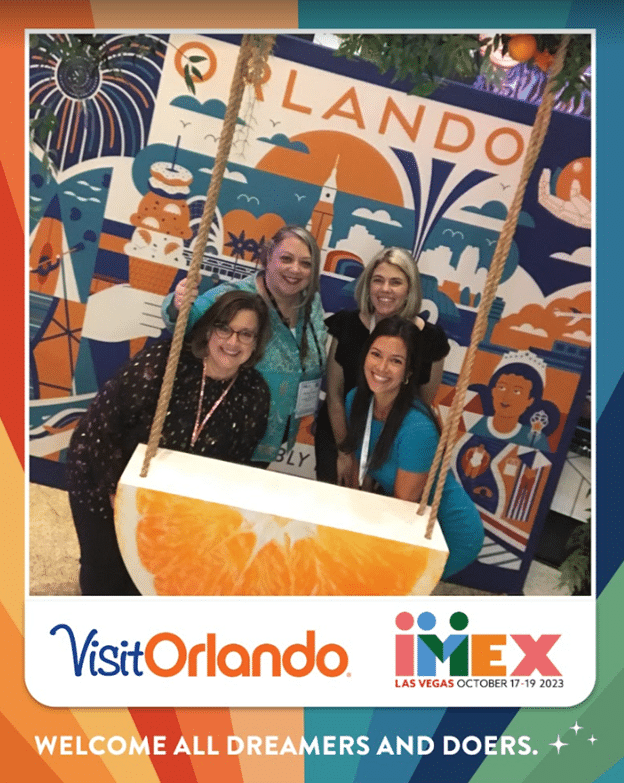 Group photo of four M&IW employees at IMEX America 2023