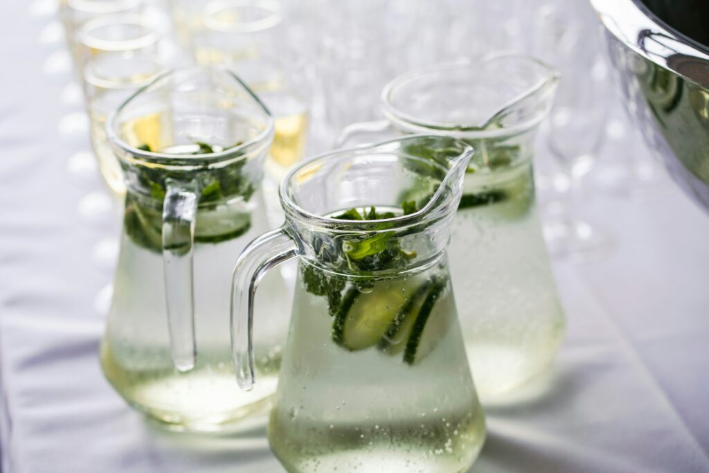 Glass water carafes with glasses waiting to be filled