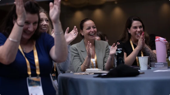 Attendees cheering at a conference session