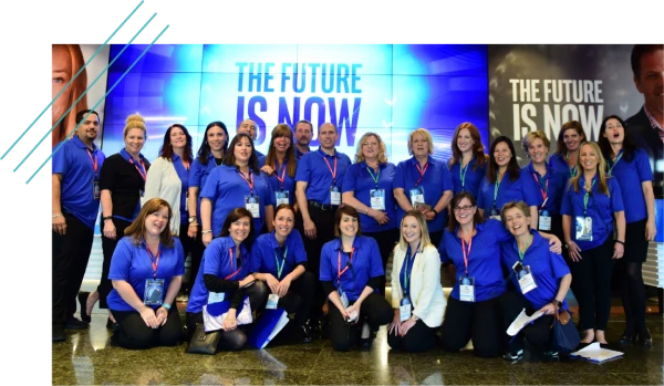 Large conference team photo in front of a stage