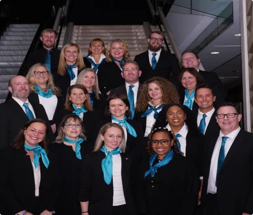 Event staff team in matching uniforms on a staircase
