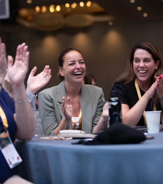 Attendees applauding at a corporate event