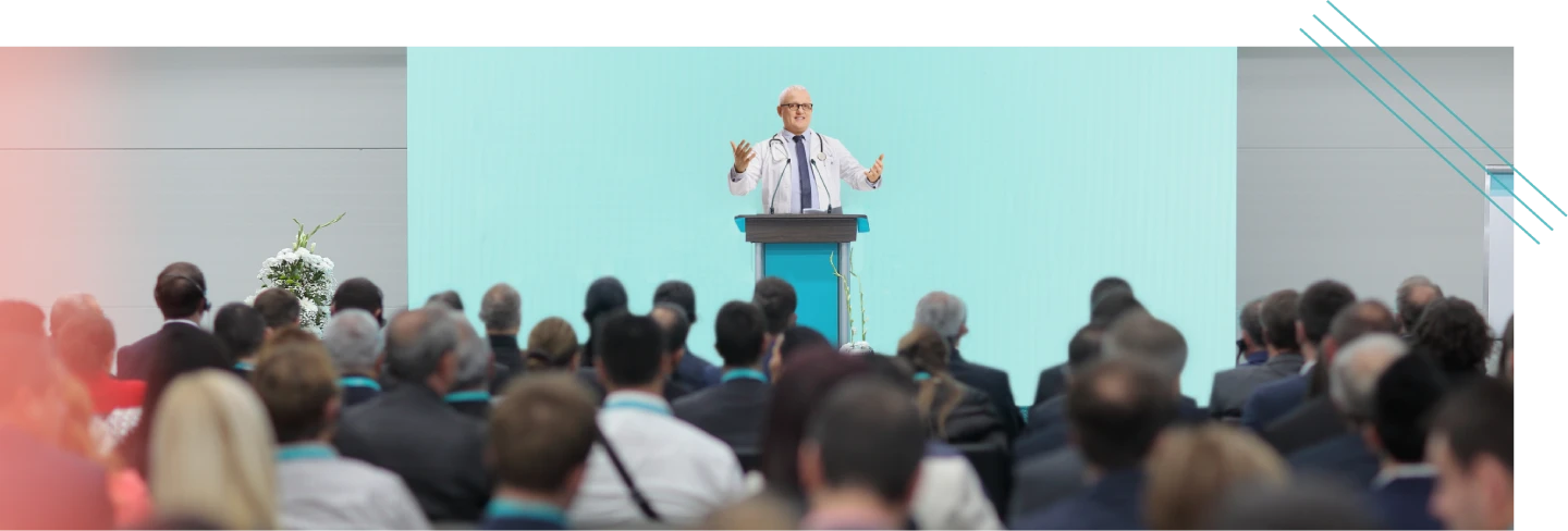 Speaker addressing an audience at a medical meeting