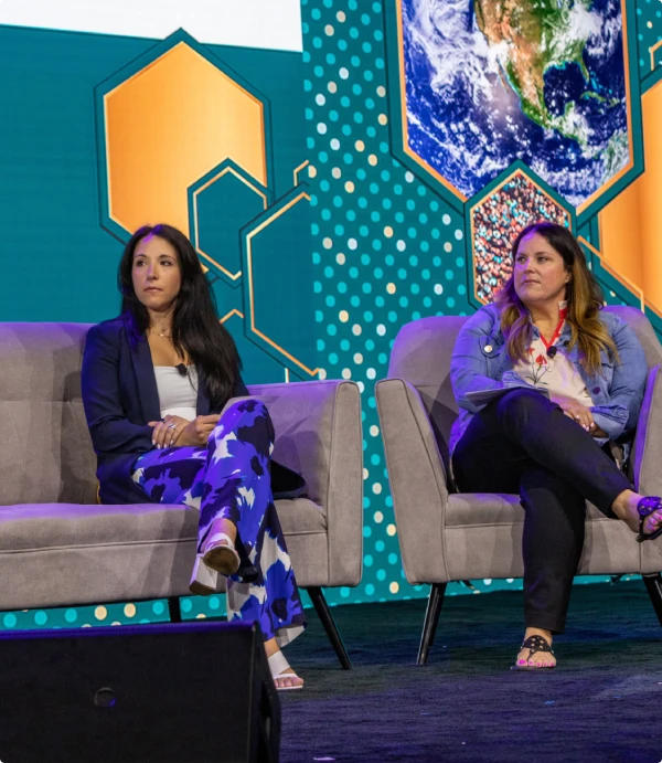 Panel speakers on stage at a conference