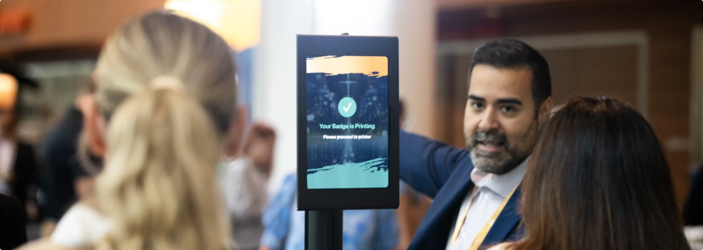 Attendee using a digital check-in kiosk