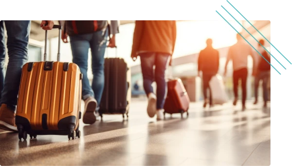 Travelers walking through an airport with luggage