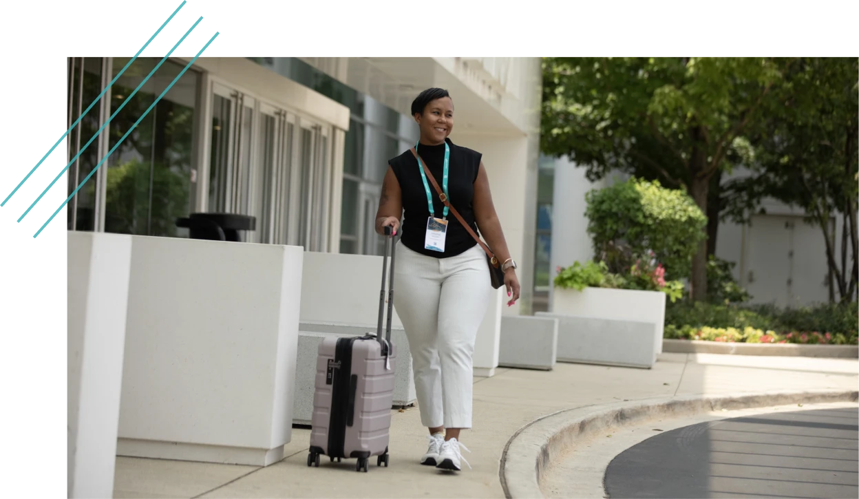 Attendee arriving at a hotel with luggage